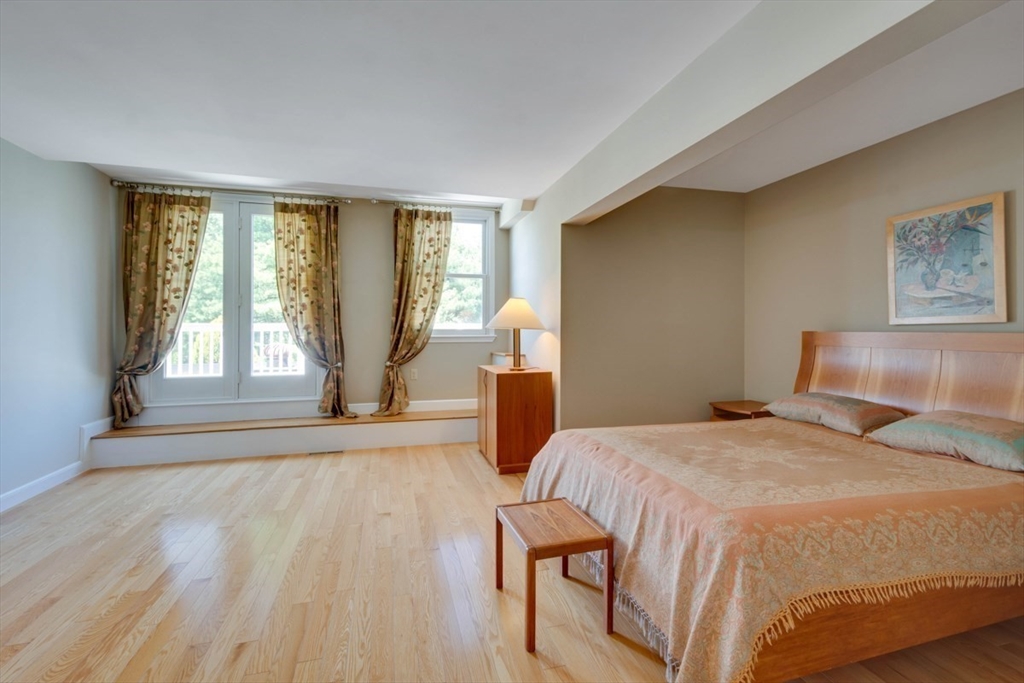 75 Page Road, Unit 16 Bedford, MA 01730 - Photo 12 of 27 a bedroom with a bed and wooden floor
