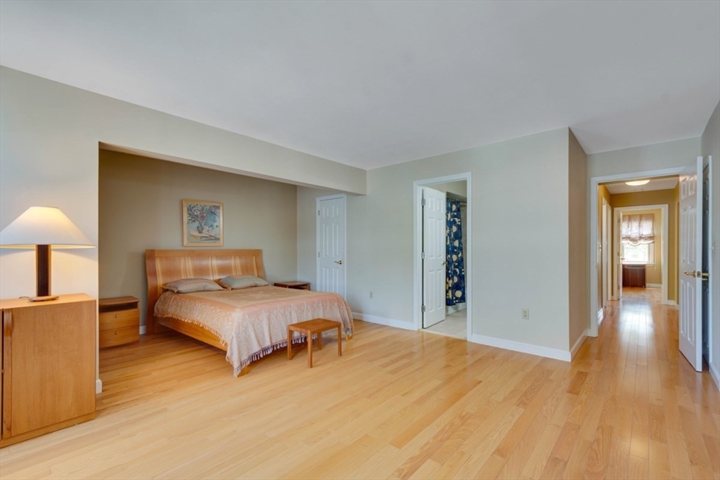 75 Page Road, Unit 16 Bedford, MA 01730 - Photo 13 of 27 a bedroom with a bed and lamp