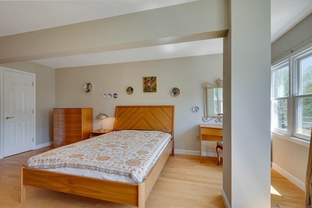 75 Page Road, Unit 16 Bedford, MA 01730 - Photo 18 of 27 a bedroom with a large bed and a dresser