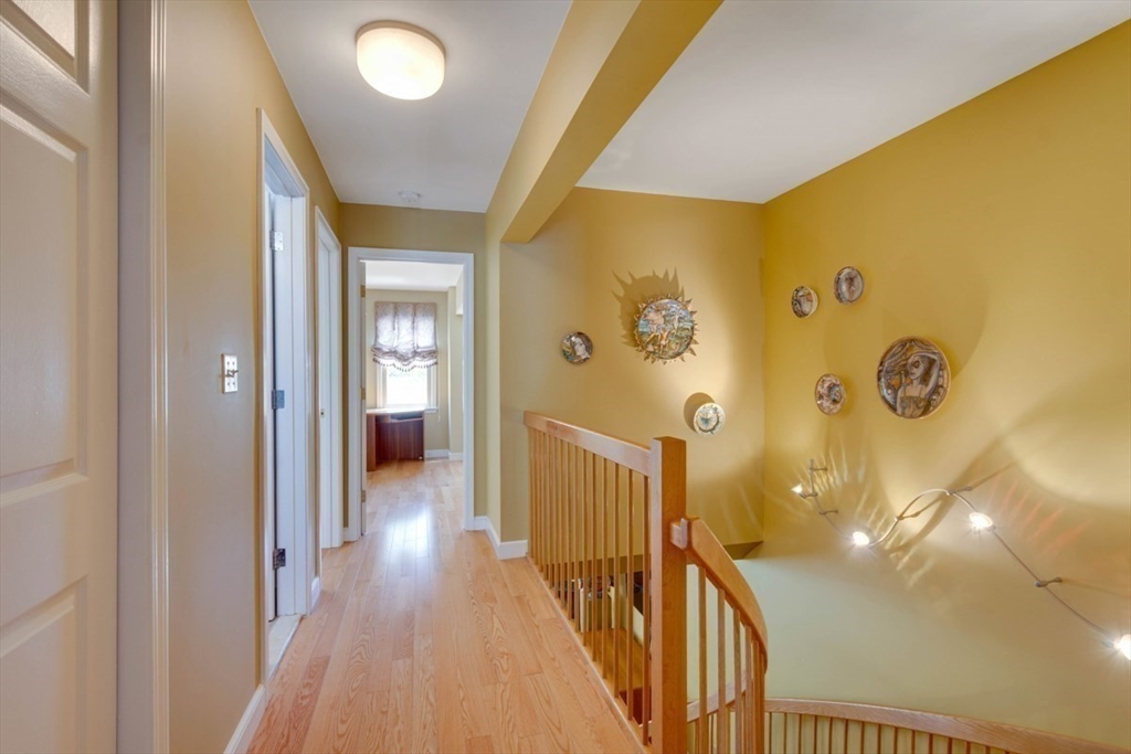 75 Page Road, Unit 16 Bedford, MA 01730 - Photo 20 of 27 a view of a hallway with wooden floor and staircase