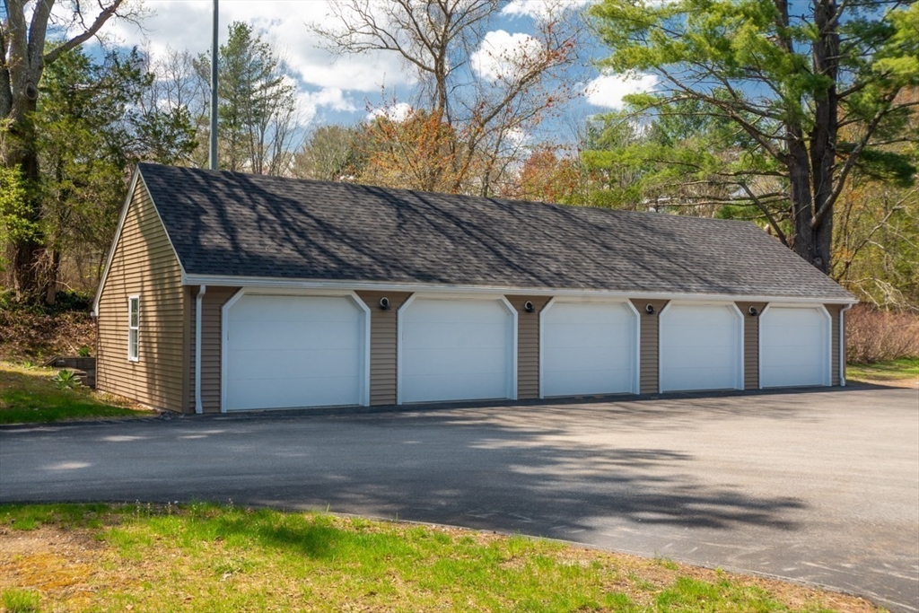 75 Page Road, Unit 16 Bedford, MA 01730 - Photo 23 of 27 a house with a swimming pool in front of it