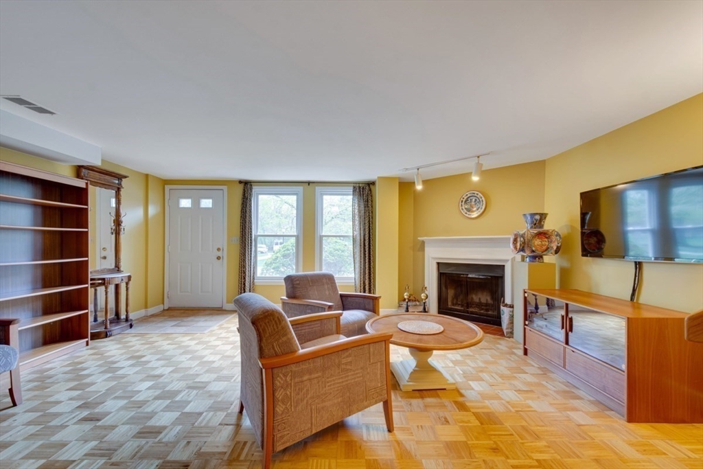 75 Page Road, Unit 16 Bedford, MA 01730 - Photo 3 of 27 a living room with furniture a fireplace and a flat screen tv