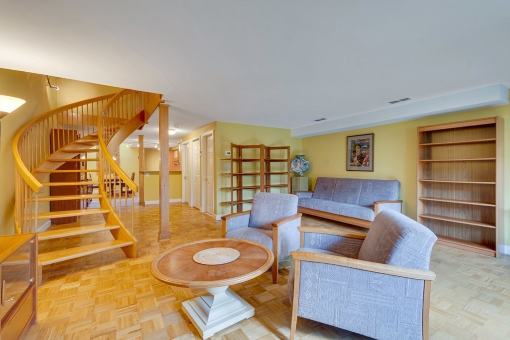 75 Page Road, Unit 16 Bedford, MA 01730 - Photo 5 of 27 a living room with furniture and a table