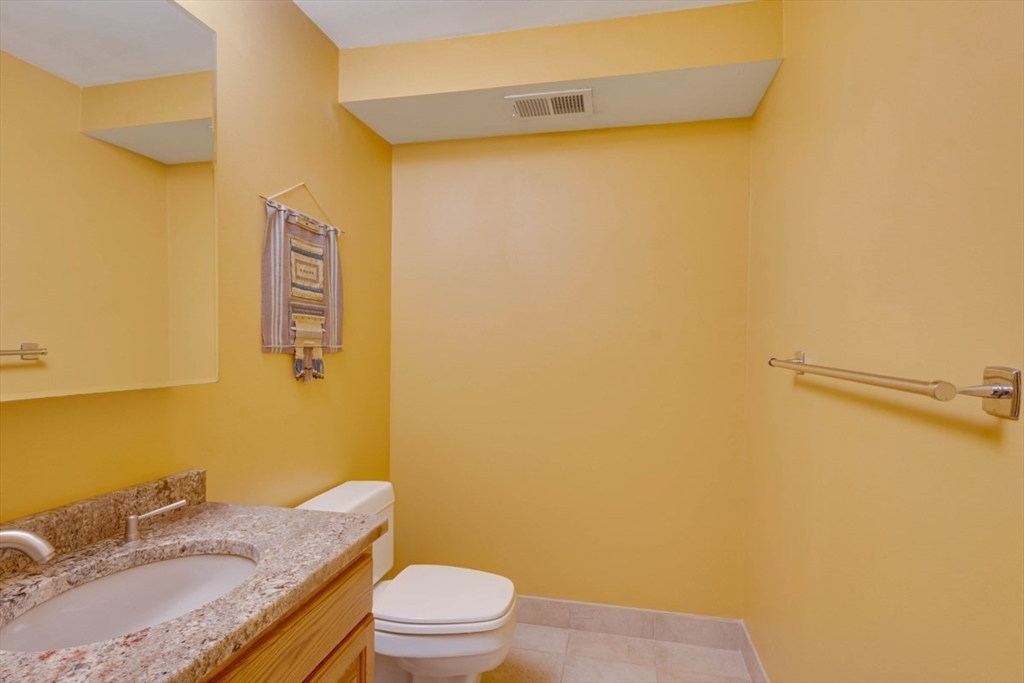 75 Page Road, Unit 16 Bedford, MA 01730 - Photo 10 of 27 a bathroom with a granite countertop sink toilet and shower