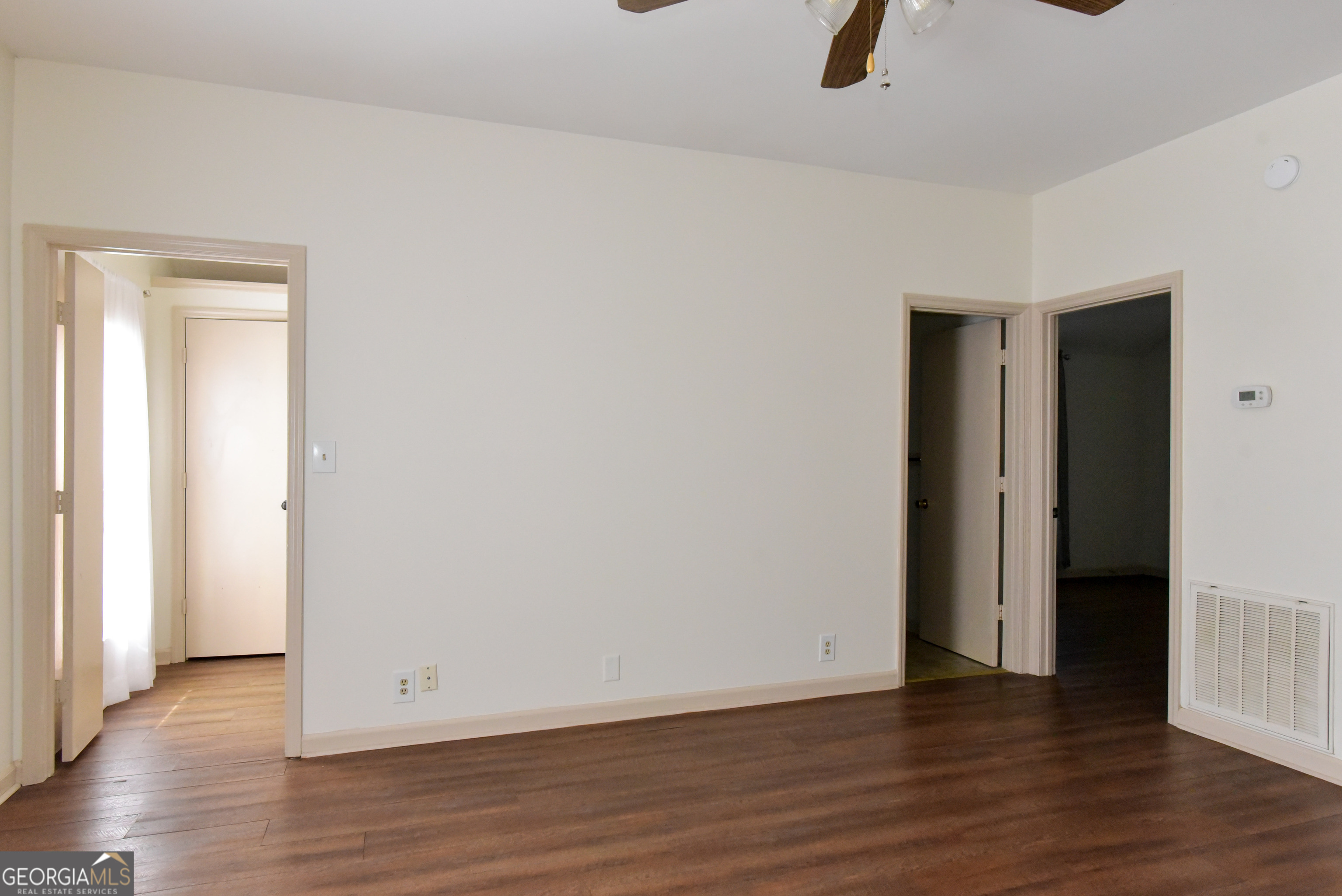 302 Jefferson Street, Unit B Springfield, GA 31329 - Photo 11 of 24 an empty room with wooden floor and windows