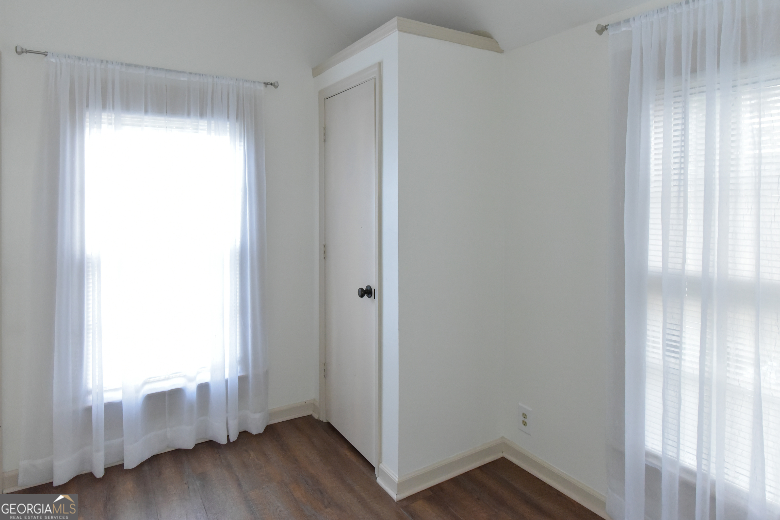 302 Jefferson Street, Unit B Springfield, GA 31329 - Photo 18 of 24 a view of an empty room with wooden floor and a window