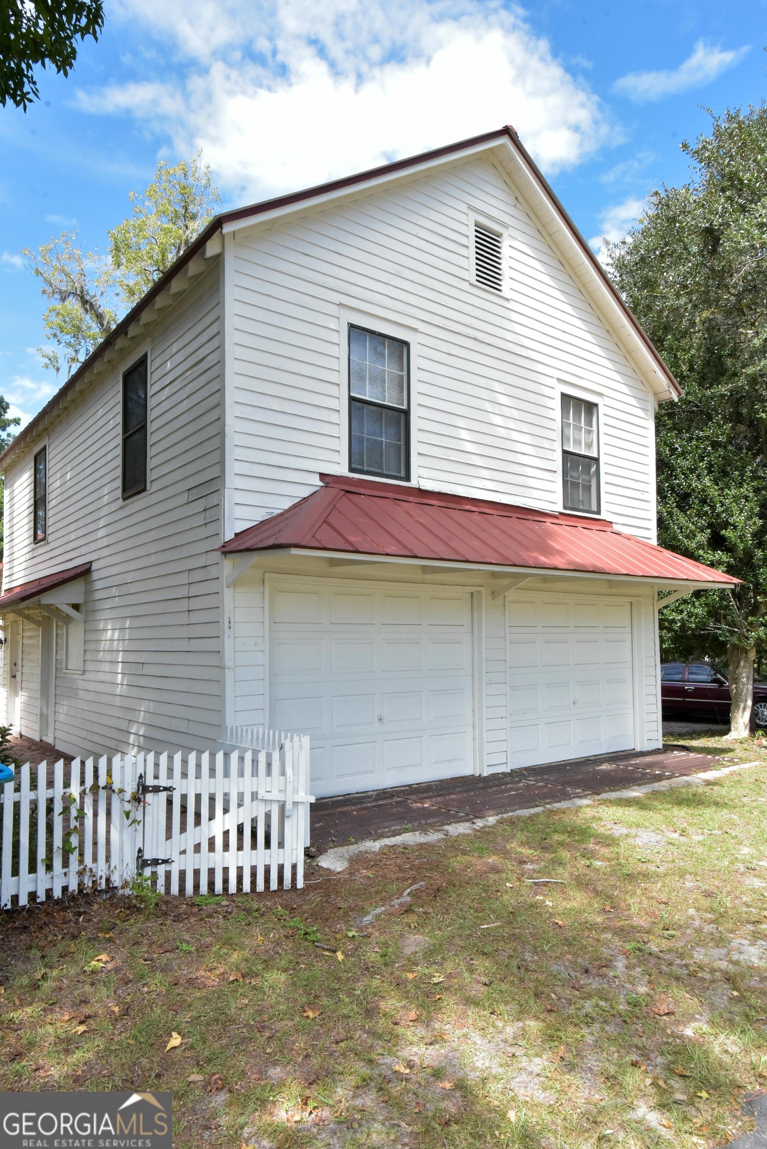 302 Jefferson Street, Unit B Springfield, GA 31329 - Photo 2 of 24 a front view of a house with garage