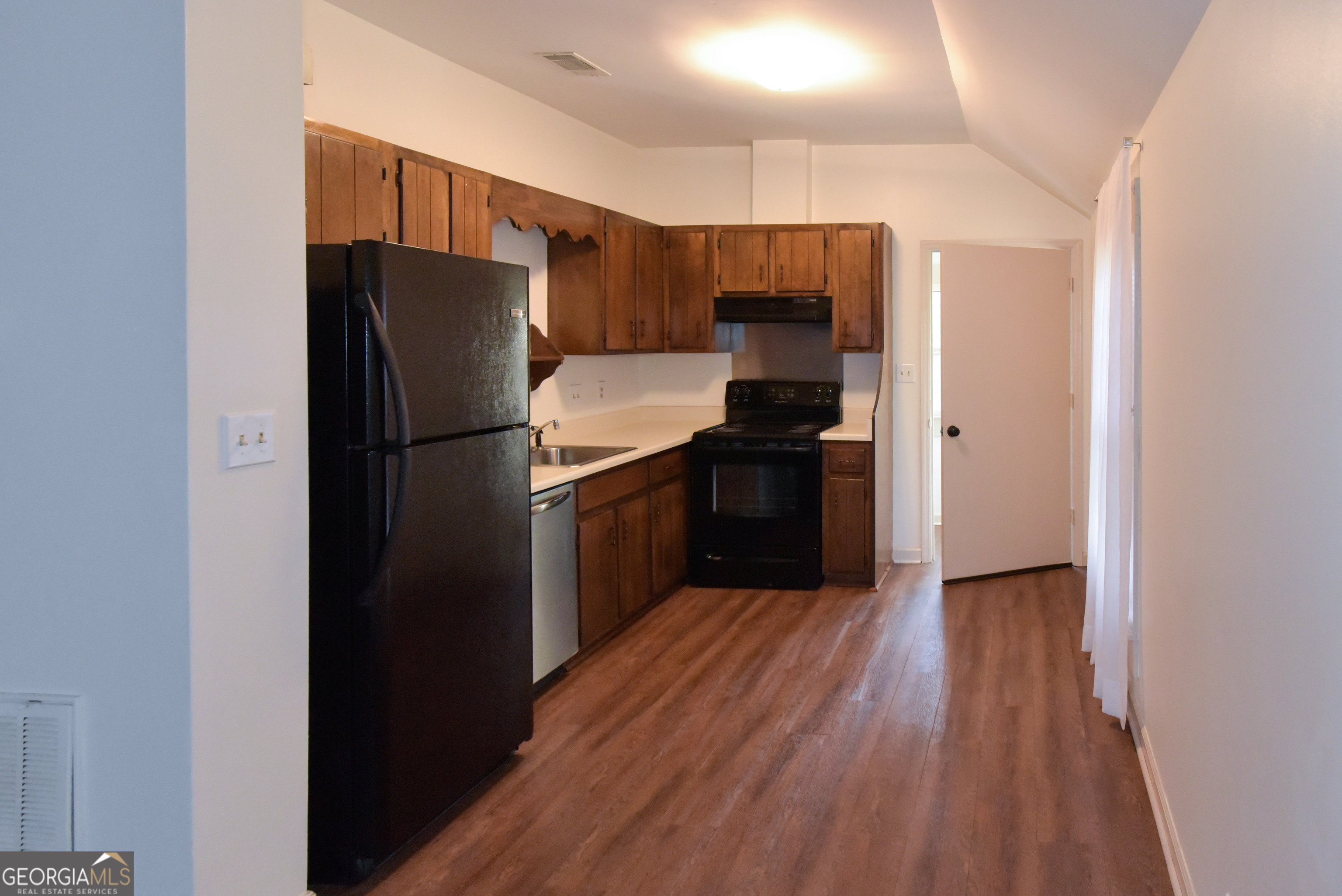 302 Jefferson Street, Unit B Springfield, GA 31329 - Photo 21 of 24 a kitchen with a refrigerator cabinet and a sink
