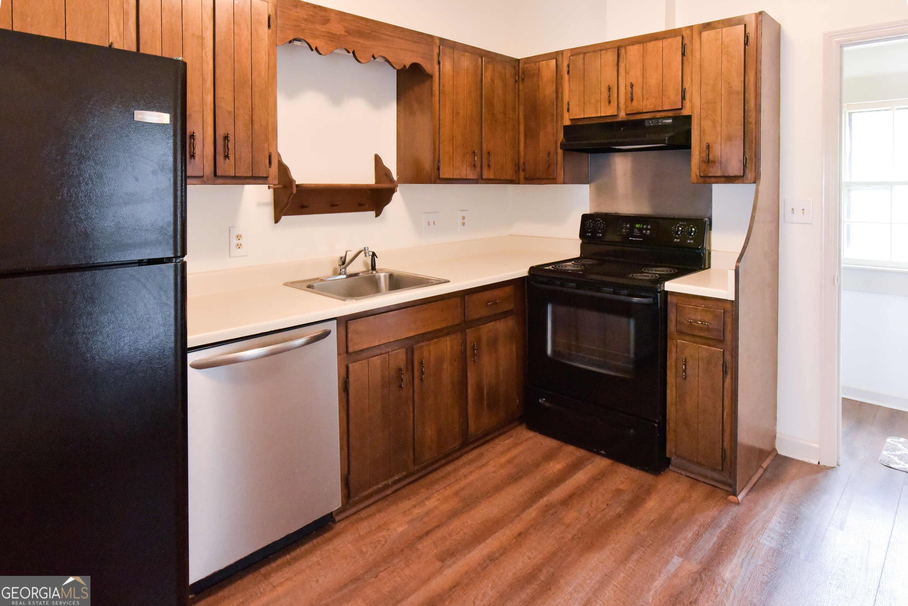 302 Jefferson Street, Unit B Springfield, GA 31329 - Photo 22 of 24 a kitchen with a sink a stove and refrigerator