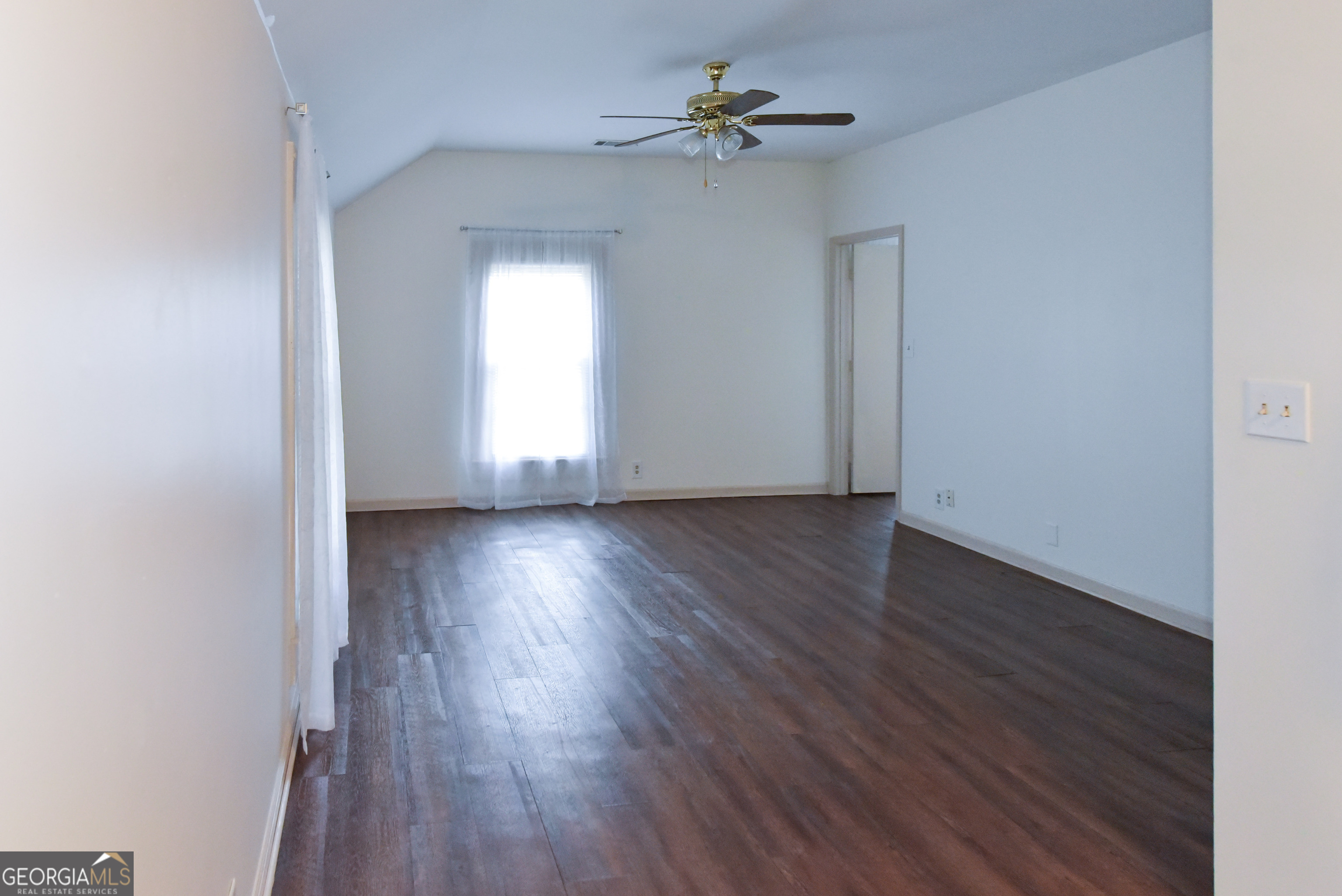 302 Jefferson Street, Unit B Springfield, GA 31329 - Photo 8 of 24 a view of empty room with wooden floor and fan