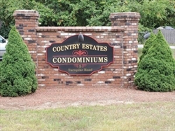 5 Turnpike Road, Unit 229 Townsend, MA 01469 - Photo 2 of 13 a sign that is sitting on a brick wall