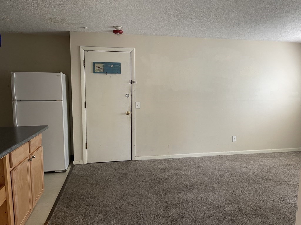 5 Turnpike Road, Unit 229 Townsend, MA 01469 - Photo 7 of 13 an empty room with a kitchen
