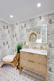 a spacious bedroom with a large bed and a painting on the wall