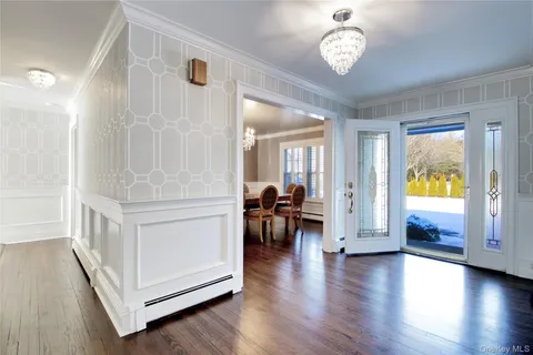 a dining room with furniture and a chandelier