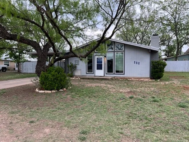 a house with trees in the background