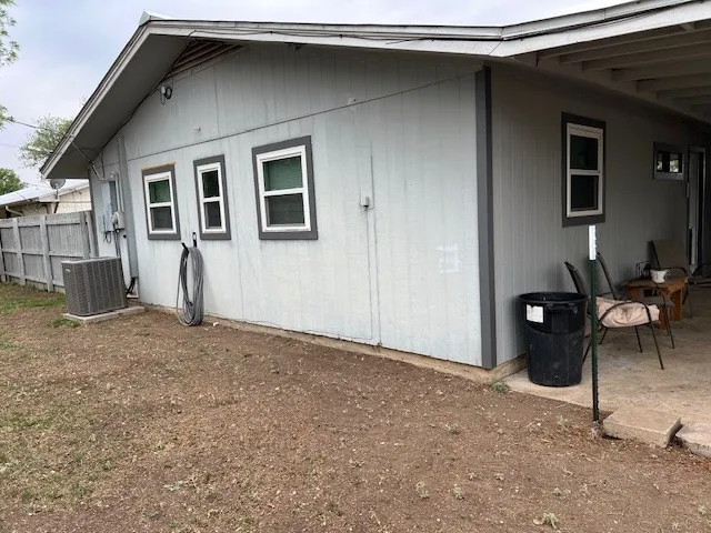 a view of backyard with wooden fence