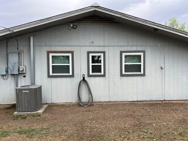a view of backyard with table and chairs under an umbrella