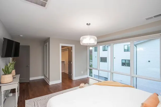 a bedroom with a bed and a flat screen tv