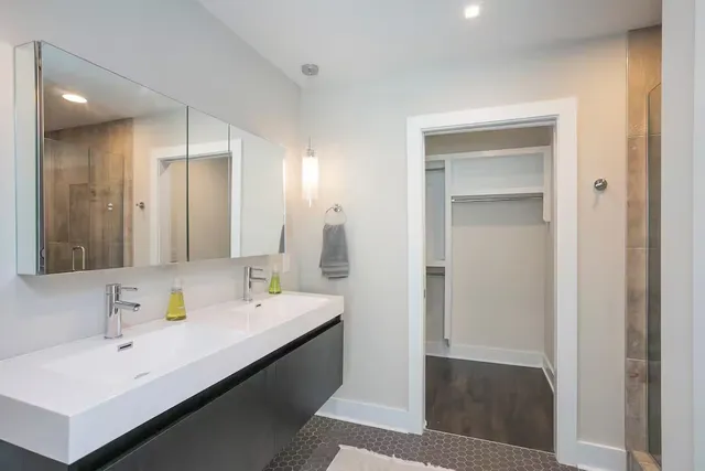a bathroom with a sink a mirror and a shower
