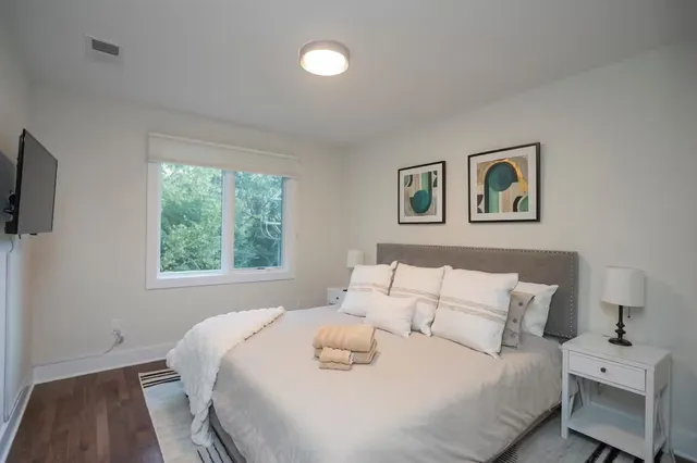 a bedroom with a bed and a window