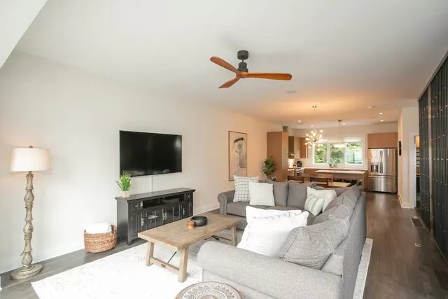 a living room with furniture a fireplace and a flat screen tv