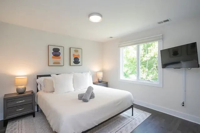 a bedroom with a bed and a flat screen tv