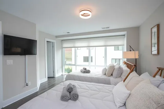 a bedroom with a bed and a flat screen tv