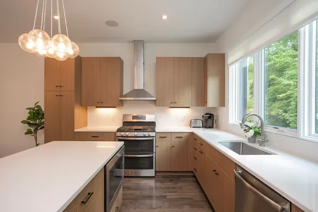 a kitchen with a sink stove and cabinets