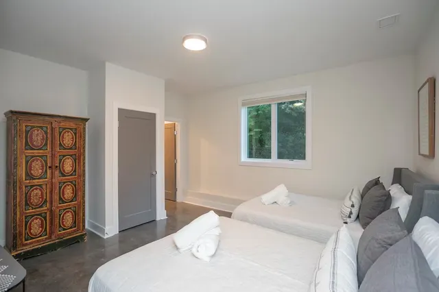 a bedroom with a bed and a window