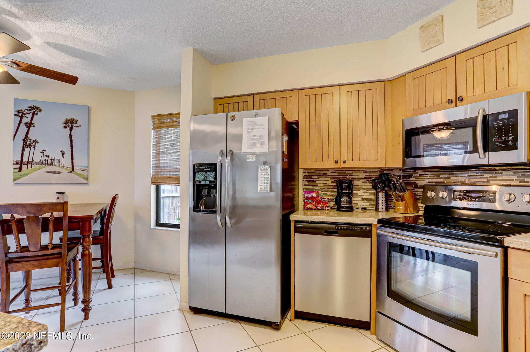 1756 Riley Street Jacksonville Beach, FL 32250 - Photo 12 of 44 a kitchen with stainless steel appliances granite countertop a refrigerator stove and microwave