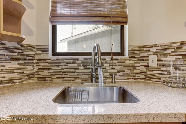 a kitchen with sink and a wooden floor