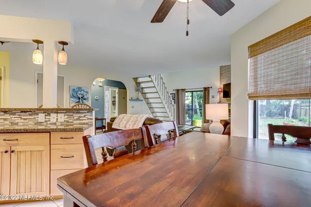 a living room with furniture and large windows