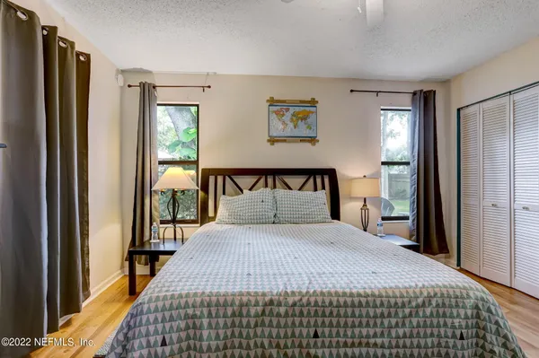 a bedroom with a large bed and a window
