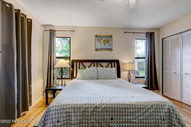 a bedroom with a large bed and a window