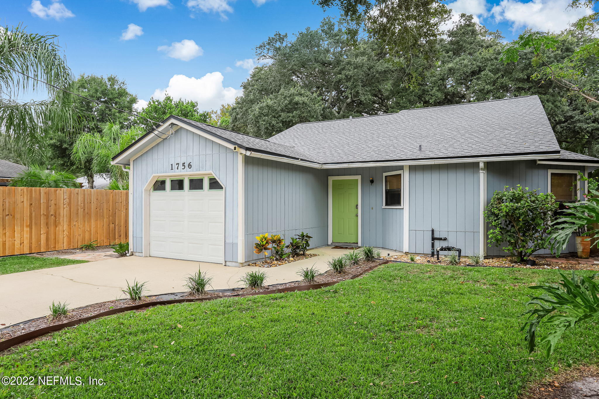1756 Riley Street Jacksonville Beach, FL 32250 - Photo 3 of 44 a front view of a house with a garden and yard