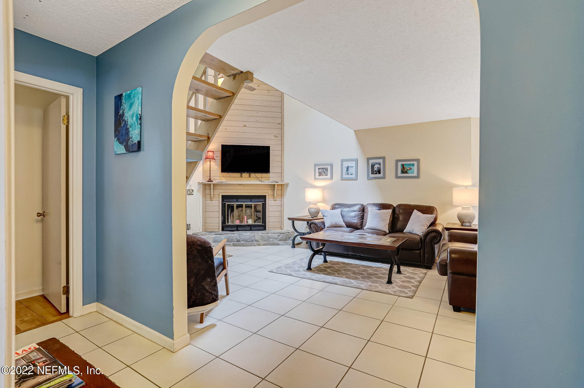 1756 Riley Street Jacksonville Beach, FL 32250 - Photo 31 of 44 a living room with furniture a fireplace and a flat screen tv
