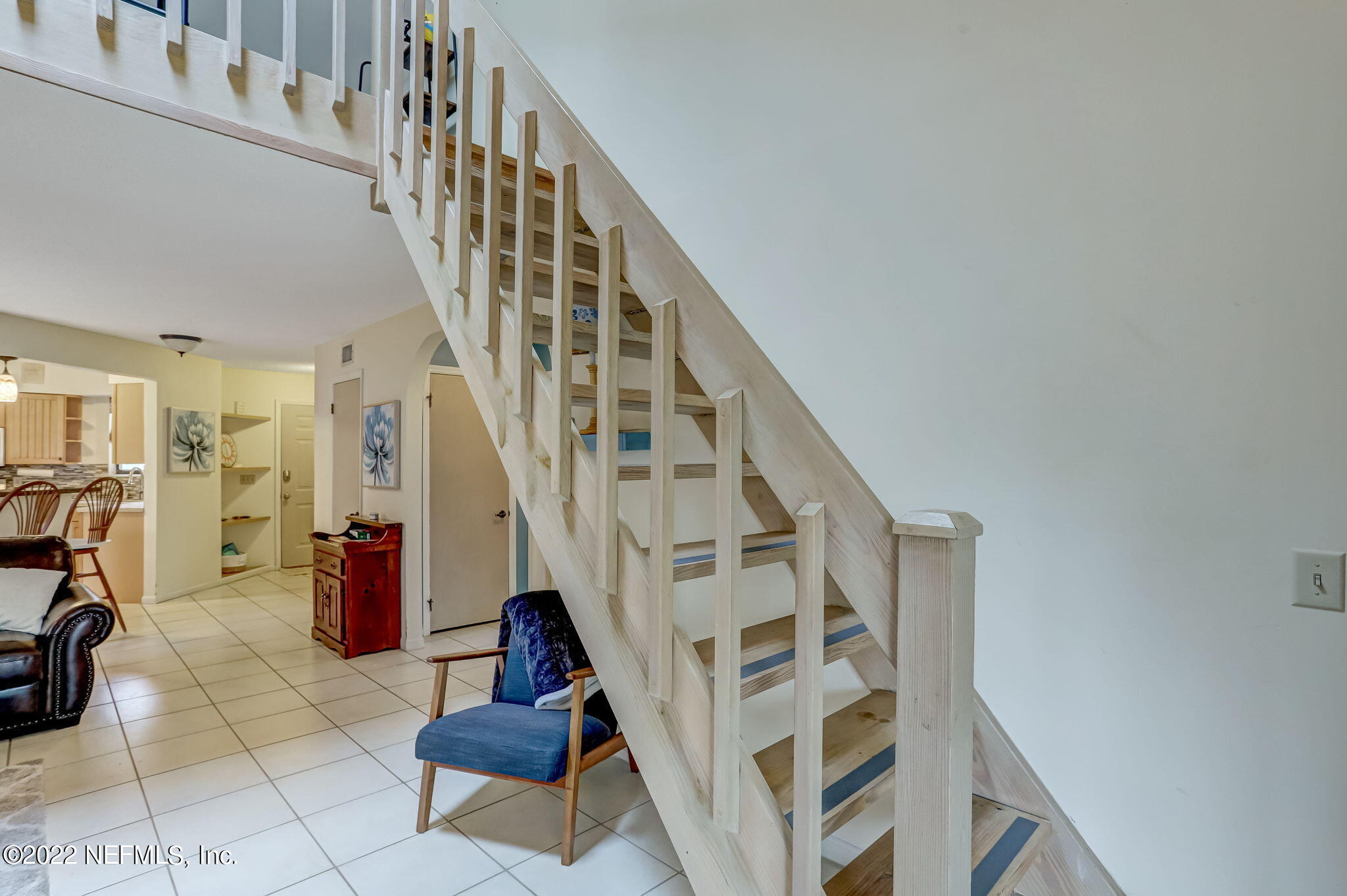 1756 Riley Street Jacksonville Beach, FL 32250 - Photo 32 of 44 a view of staircase with lots of frames on wall and a rug