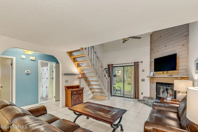 a living room with furniture fireplace and flat screen tv