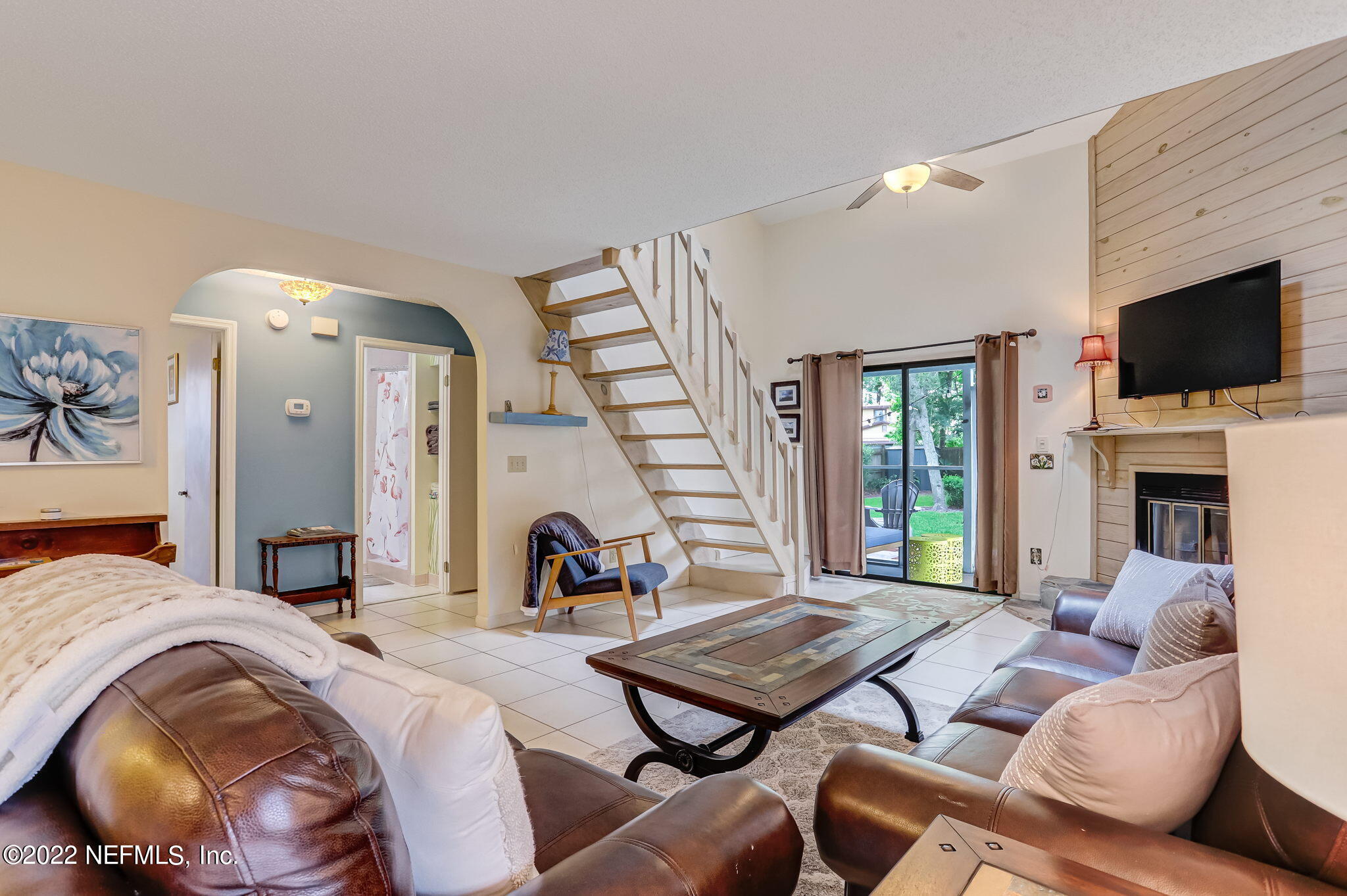 1756 Riley Street Jacksonville Beach, FL 32250 - Photo 7 of 44 a living room with fireplace furniture and a flat screen tv