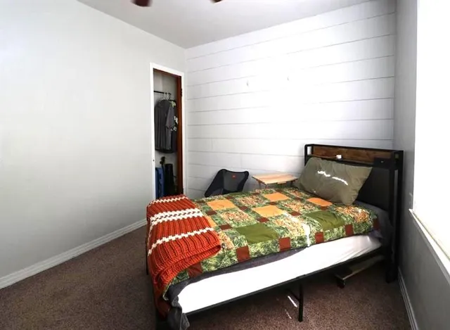 a bed sitting in a bedroom next to a window