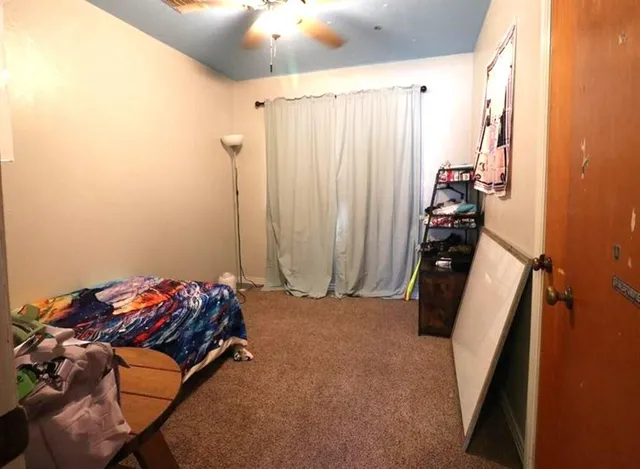 a bedroom with a bed and a window