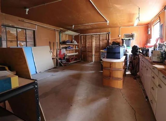 a backyard of a house with table and chairs