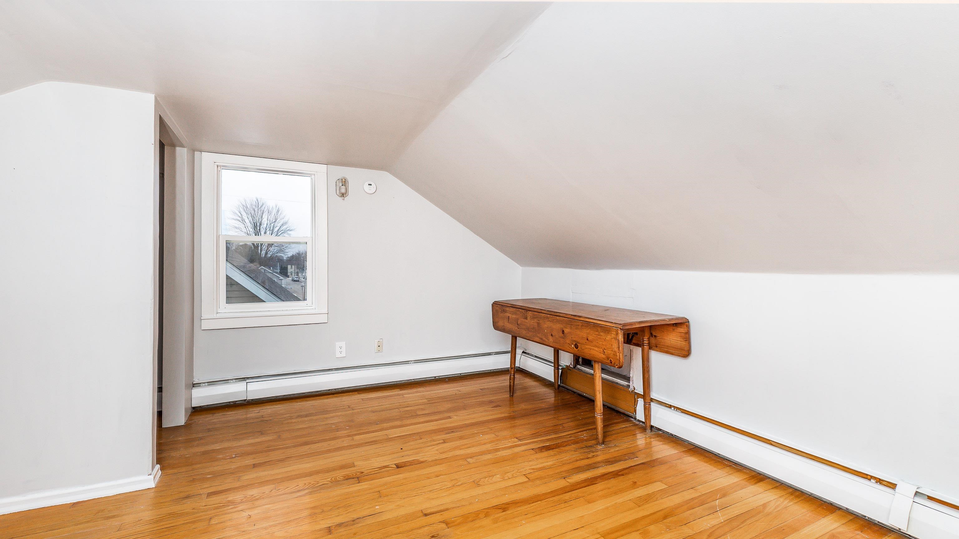 803 Ridge Street Galena, IL 61036 - Photo 25 of 40 a view of an empty room with wooden floor and a window