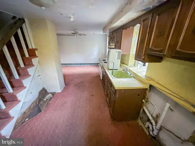 a kitchen with stainless steel appliances granite countertop a sink stove and a refrigerator