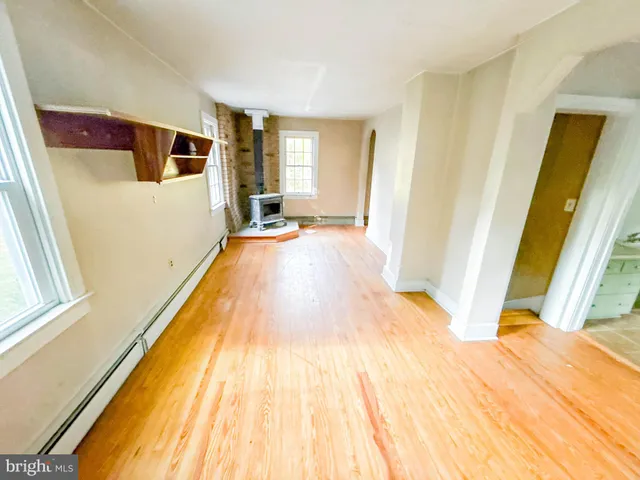 wooden floor in an empty room with a window
