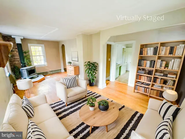 a living room with furniture and a book shelf