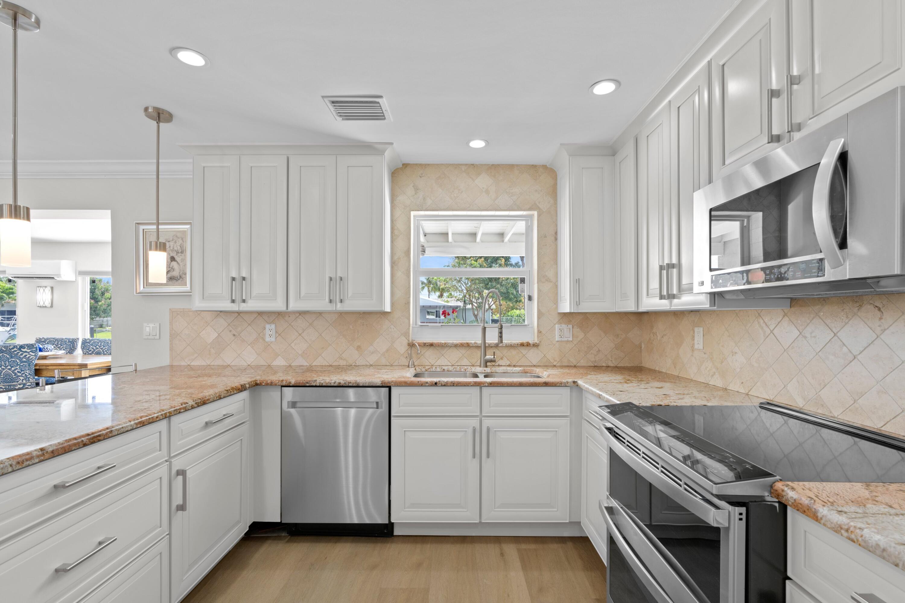 398 Southwest 13th Place Boca Raton, FL 33432 - Photo 11 of 36 a kitchen that has a sink and a stove in it