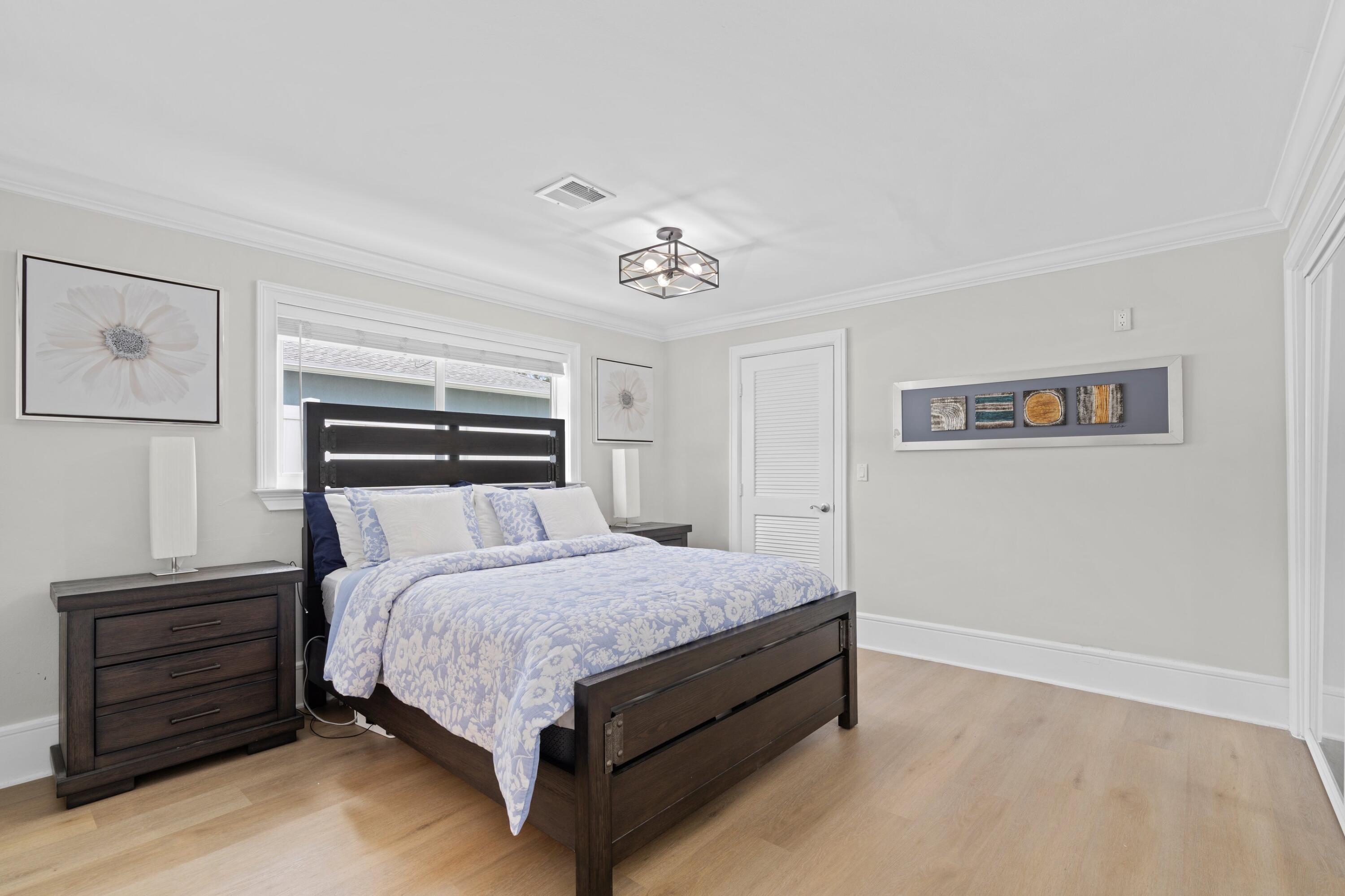 398 Southwest 13th Place Boca Raton, FL 33432 - Photo 12 of 36 a bedroom with a bed and a night stand