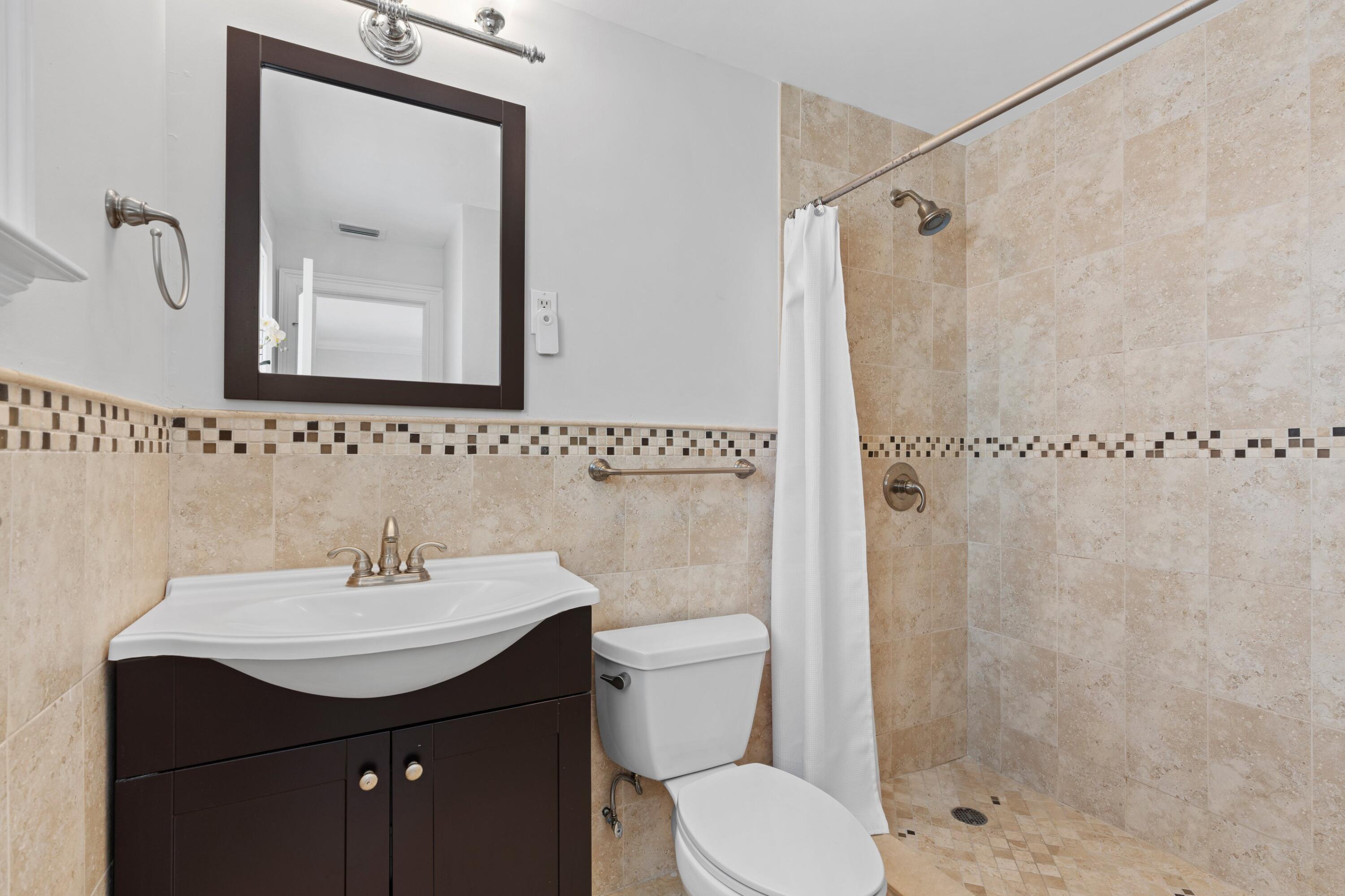 398 Southwest 13th Place Boca Raton, FL 33432 - Photo 16 of 36 a bathroom with a sink and a mirror
