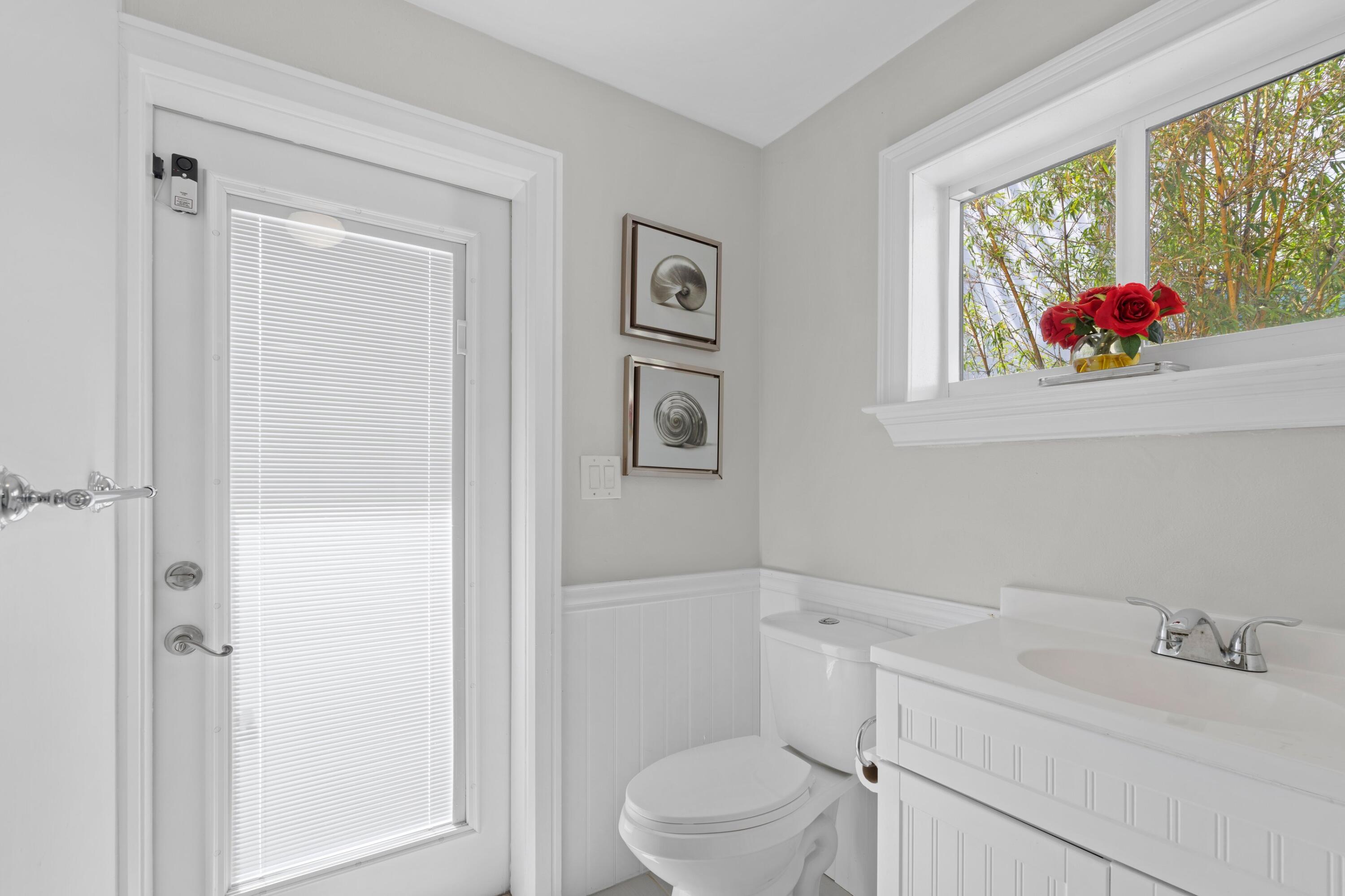 398 Southwest 13th Place Boca Raton, FL 33432 - Photo 17 of 36 a bathroom with a toilet sink and mirror